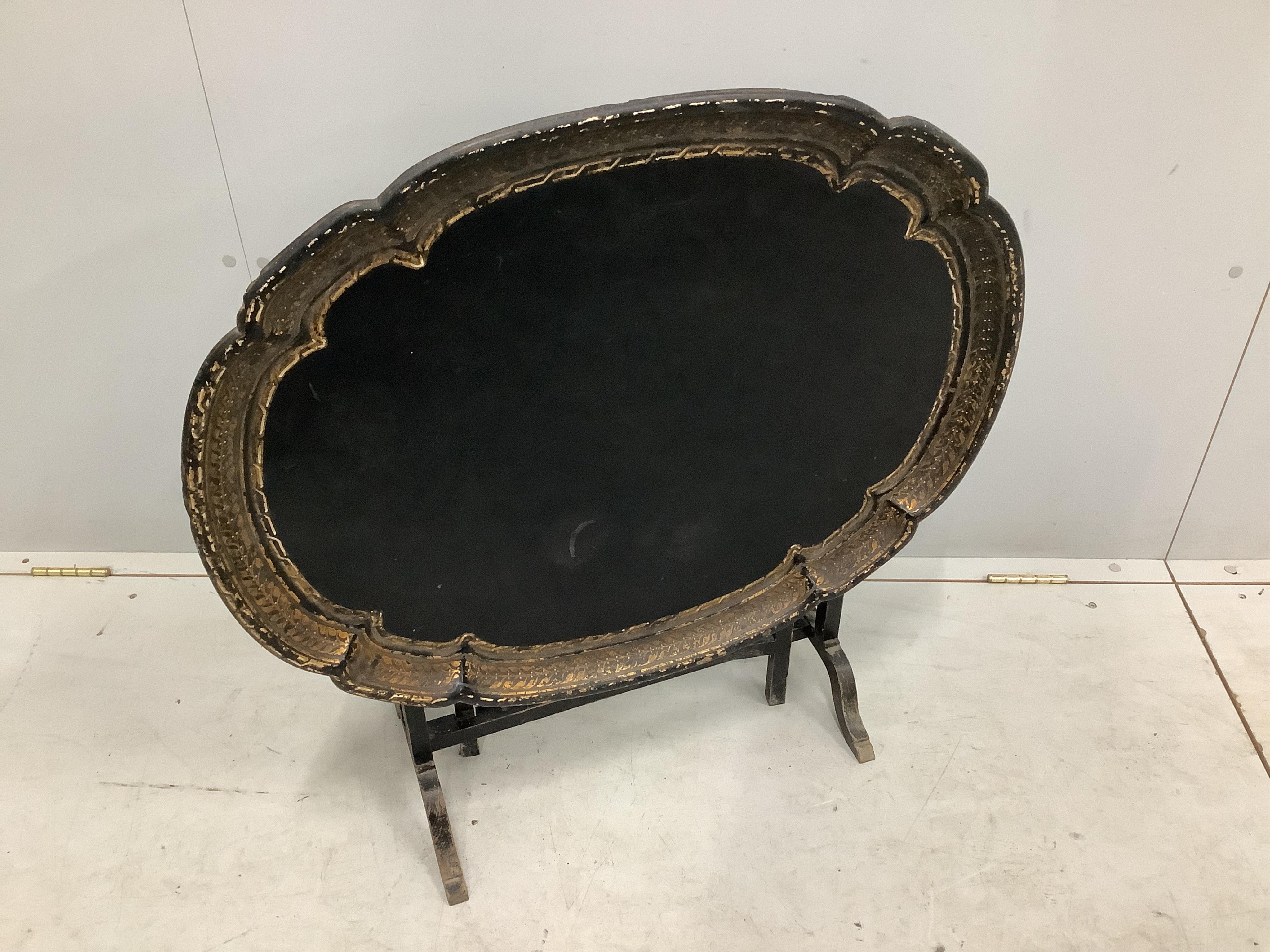 A Victorian oval papier mache folding occasional table, width 79cm, depth 64cm, height 54cm. Condition - fair